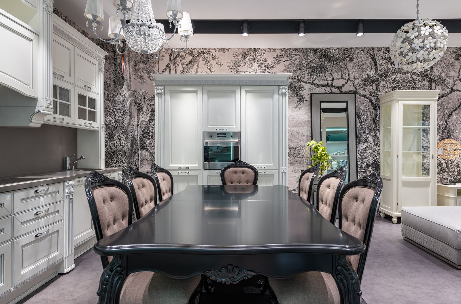 Elegant dining room with a monochrome forest mural wallpaper, crystal chandelier and black lacquered dining table